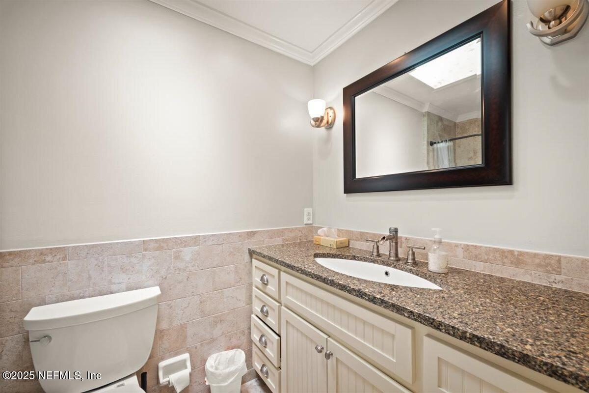 2477 Ridgecrest Avenue Orange Park, FL 32065 - Photo 23 of 28 a bathroom with a toilet sink and mirror