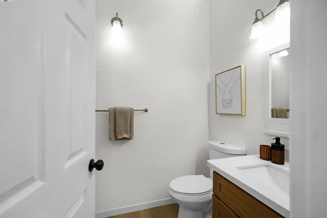 a bathroom with a sink toilet and mirror