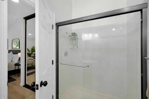 a bathroom with a glass shower door