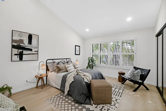 a bed room with a bed and a chair