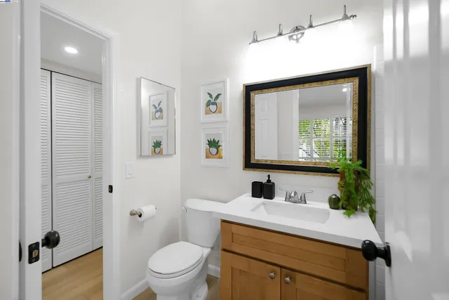 a bathroom with a sink toilet and mirror