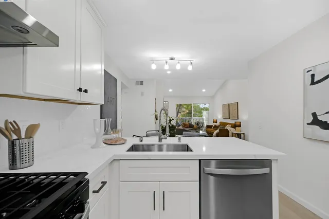 a kitchen with sink a stove and cabinets