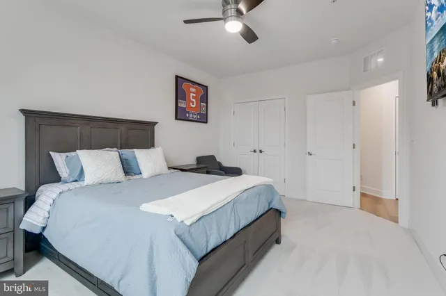 a spacious bedroom with a bed and glass windows