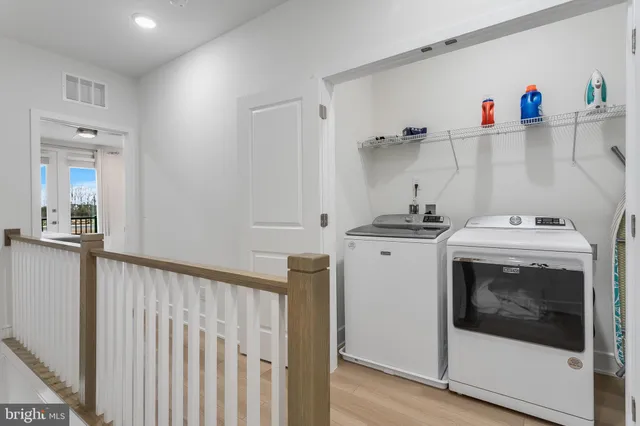 a front view of a building with lot of cars parked on road