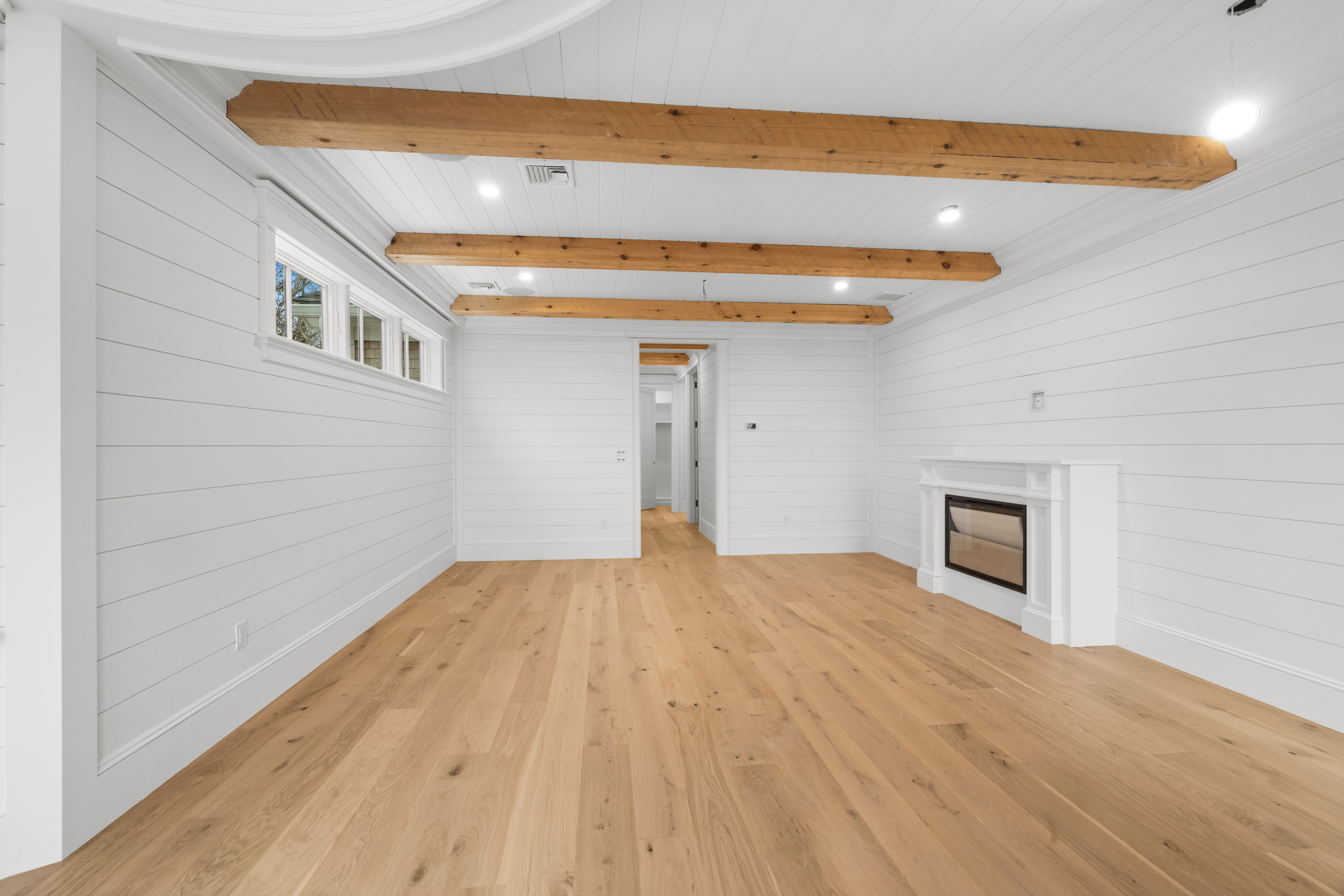 14 Trapps Pond Road Edgartown, MA 02539 - Photo 22 of 34 a view of empty room with wooden floor and fireplace