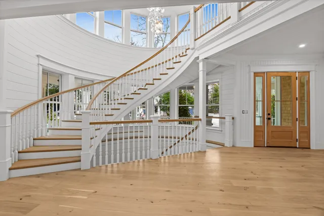 a view of staircase with lots of frames and a rug