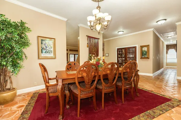 a view of a dining room with furniture wooden floor and chandelier