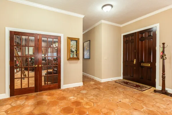 a view of an empty room with window and a bathroom