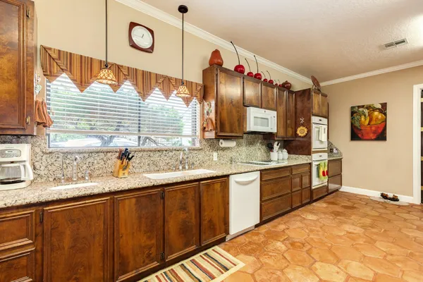 a kitchen with stainless steel appliances granite countertop a refrigerator and stove top oven