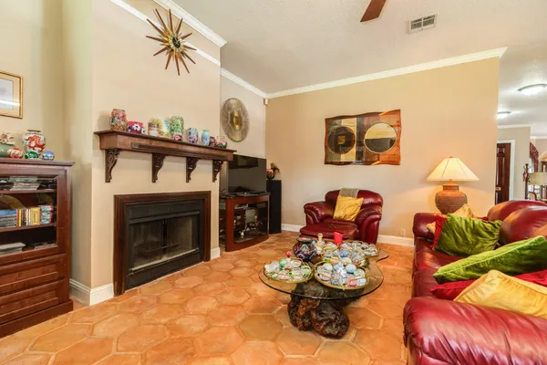 a living room with furniture a fireplace and a flat screen tv