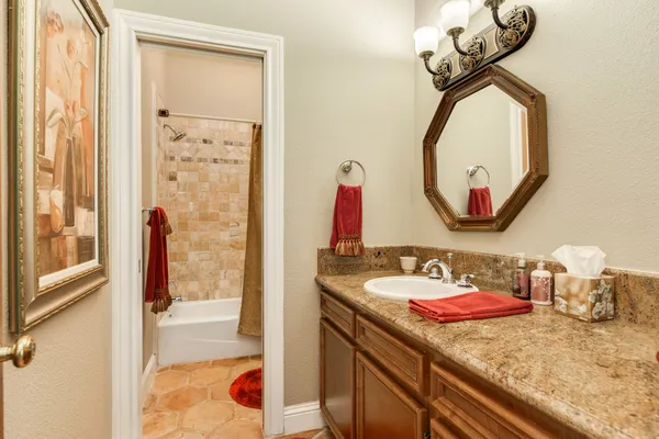 a bathroom with a sink mirror and vanity