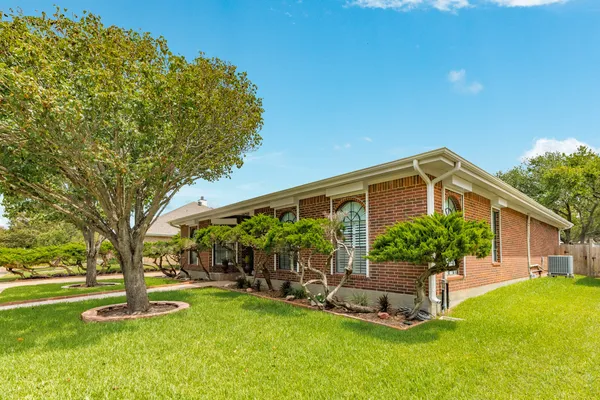 a front view of a house with a yard