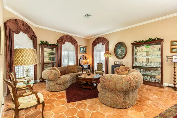 a living room with fireplace furniture and a large window