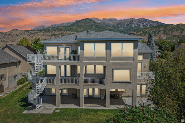 220 East Ridge Road Orem, UT 84057 - Photo 48 of 52 Multi-level exterior with stucco finish, multiple balconies, a spiral staircase, and a mountain backdrop