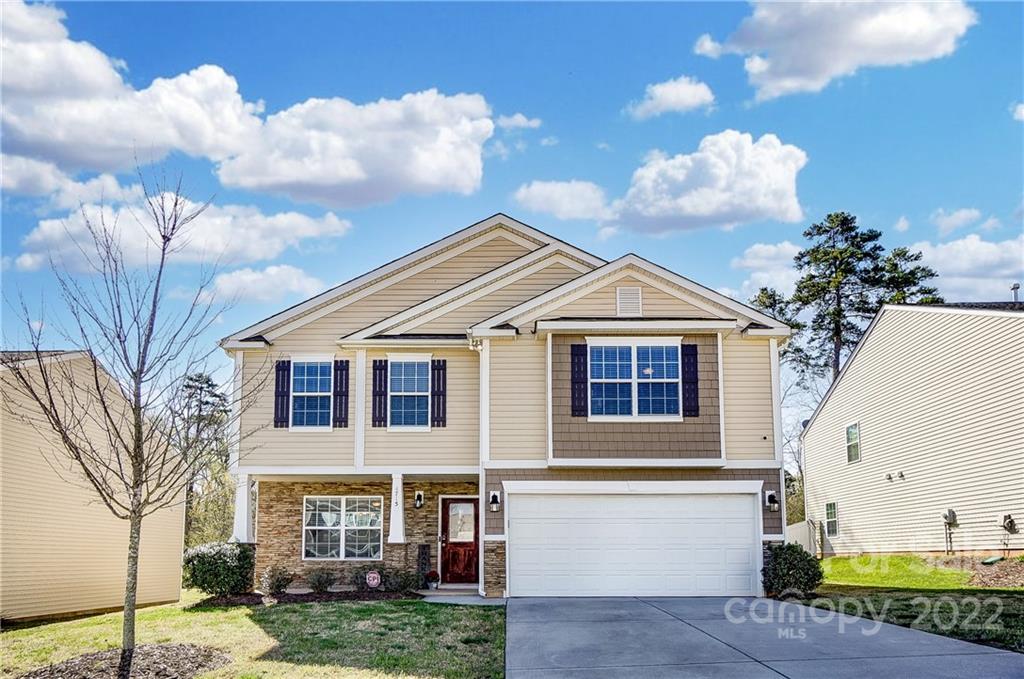 4715 McClure Road Charlotte, NC 28216 - Photo 1 of 36 a view of a white house next to a yard with big trees