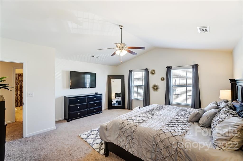 4715 McClure Road Charlotte, NC 28216 - Photo 17 of 36 a bedroom with a bed and a flat screen tv