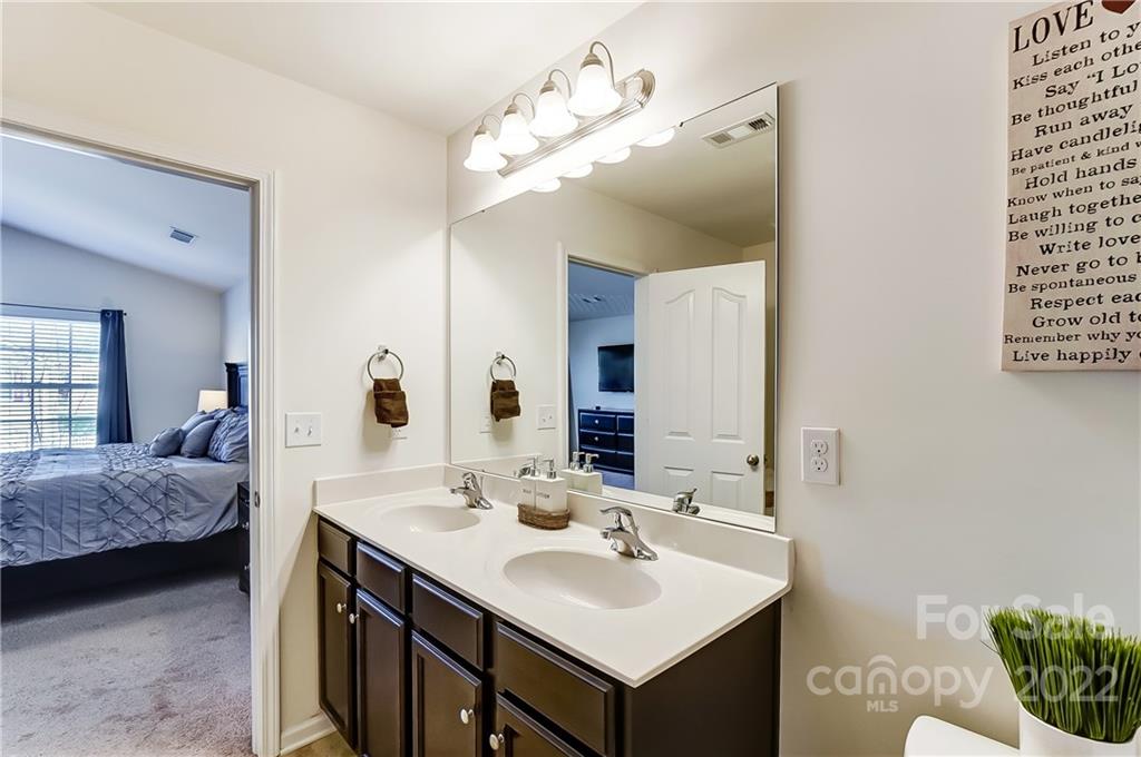 4715 McClure Road Charlotte, NC 28216 - Photo 19 of 36 a en suite bathroom with a sink and a mirror