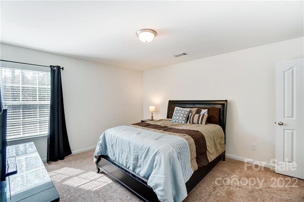 4715 McClure Road Charlotte, NC 28216 - Photo 22 of 36 a bedroom with a bed and a window