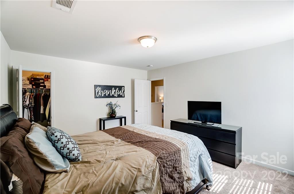 4715 McClure Road Charlotte, NC 28216 - Photo 24 of 36 a bedroom with a bed and a flat screen tv