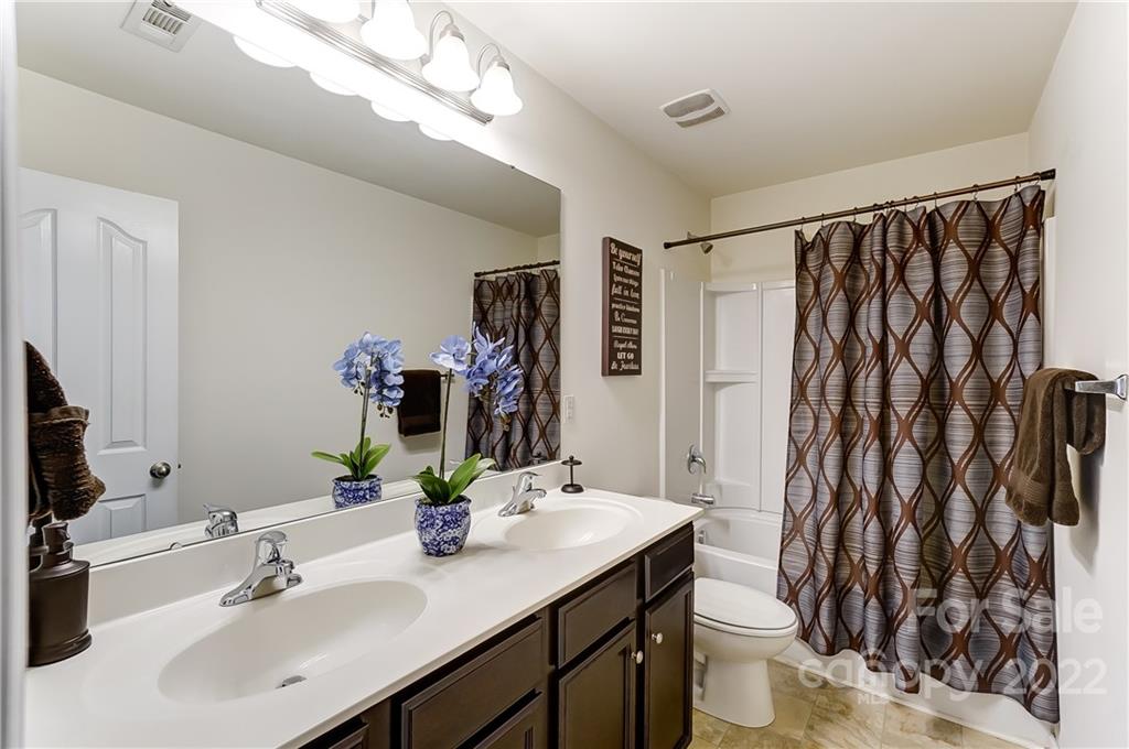 4715 McClure Road Charlotte, NC 28216 - Photo 25 of 36 a bathroom with a sink a toilet and shower