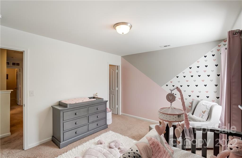 4715 McClure Road Charlotte, NC 28216 - Photo 29 of 36 a bedroom with a bed and a dresser in it