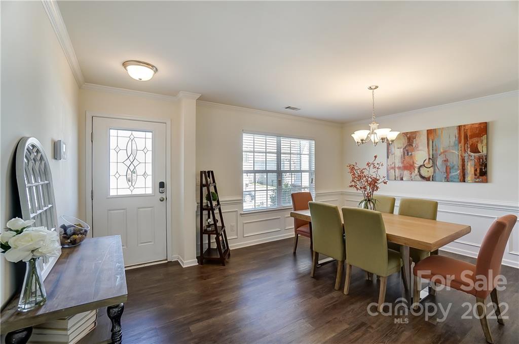 4715 McClure Road Charlotte, NC 28216 - Photo 4 of 36 a view of a dining room with furniture and wooden floor