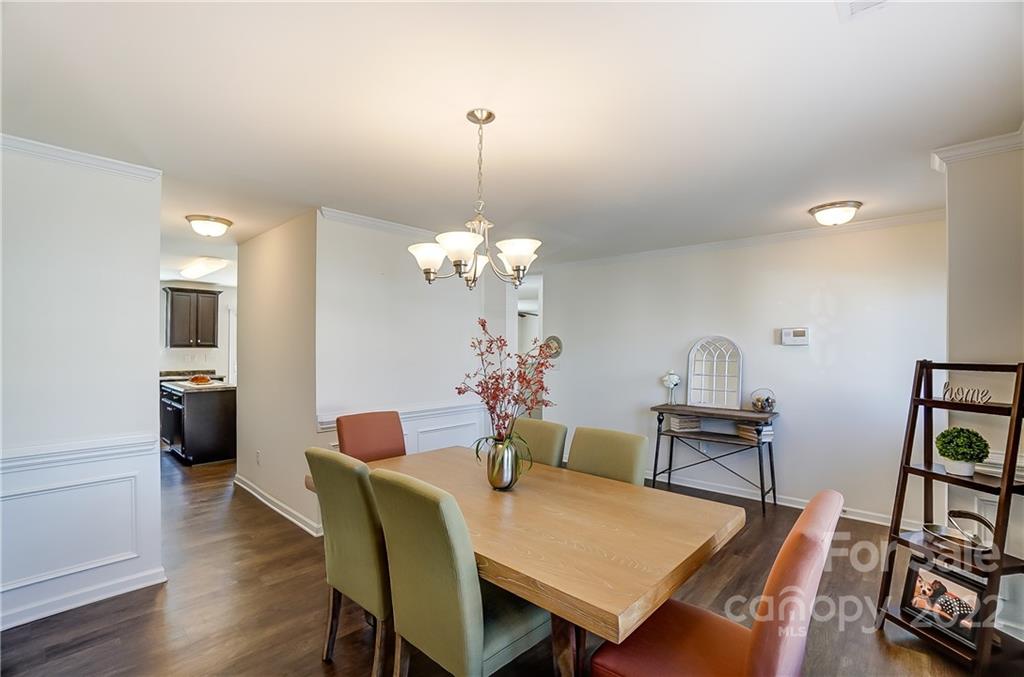 4715 McClure Road Charlotte, NC 28216 - Photo 5 of 36 a view of a dining room with furniture and wooden floor