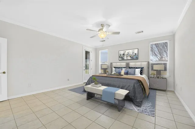 a spacious bedroom with a bed and a chandelier