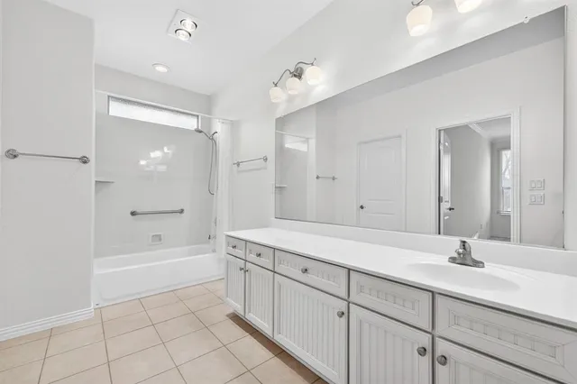 a spacious bathroom with a bathtub shower sink double and mirror