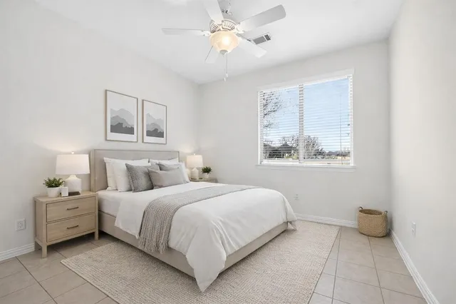 a bedroom with a bed and a window