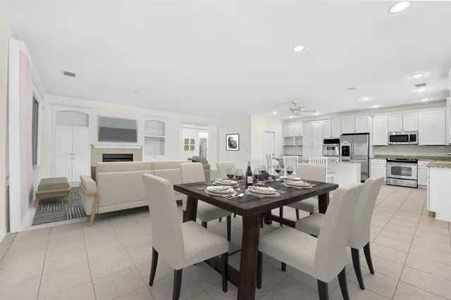 a view of a dining room with furniture and a kitchen