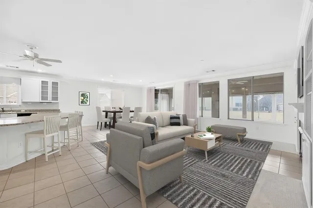 a living room with furniture and view of kitchen