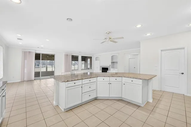 a large white kitchen with a stove a sink dishwasher and a refrigerator