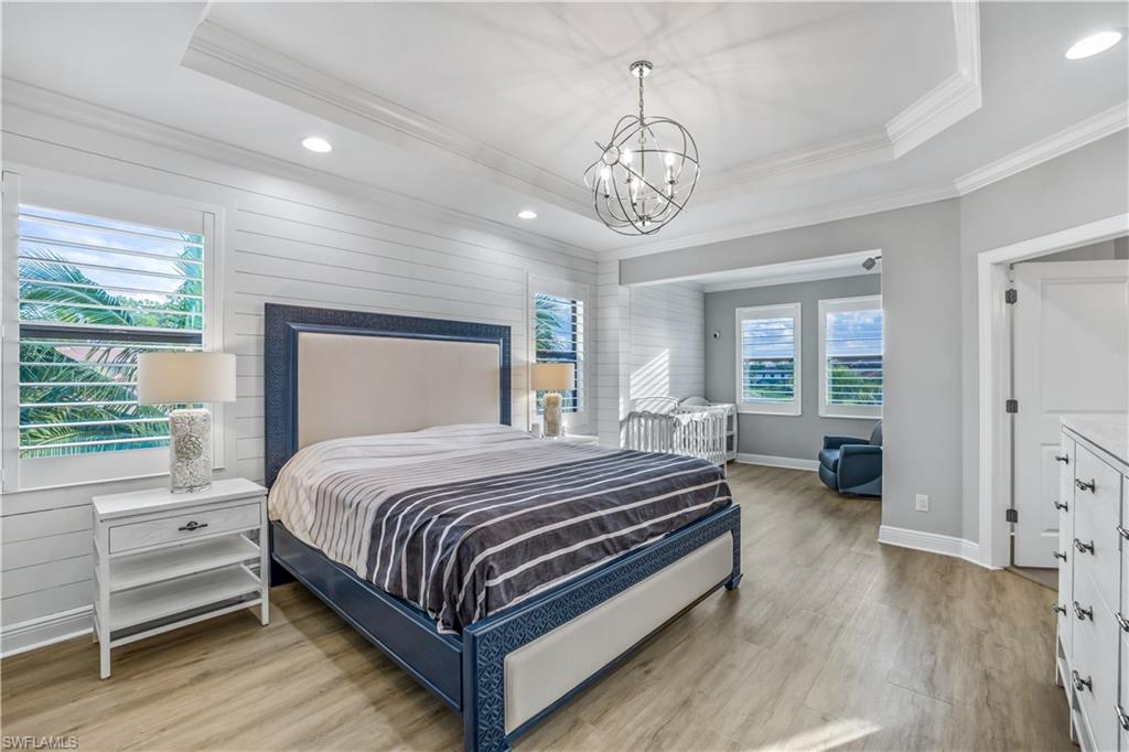4605 Abaca Circle Naples, FL 34119 - Photo 11 of 35 a bedroom with a large bed and a large window
