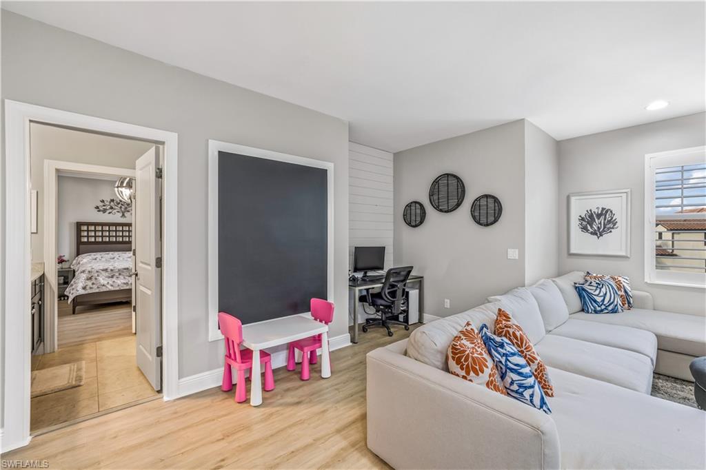 4605 Abaca Circle Naples, FL 34119 - Photo 16 of 35 a living room with furniture and a table