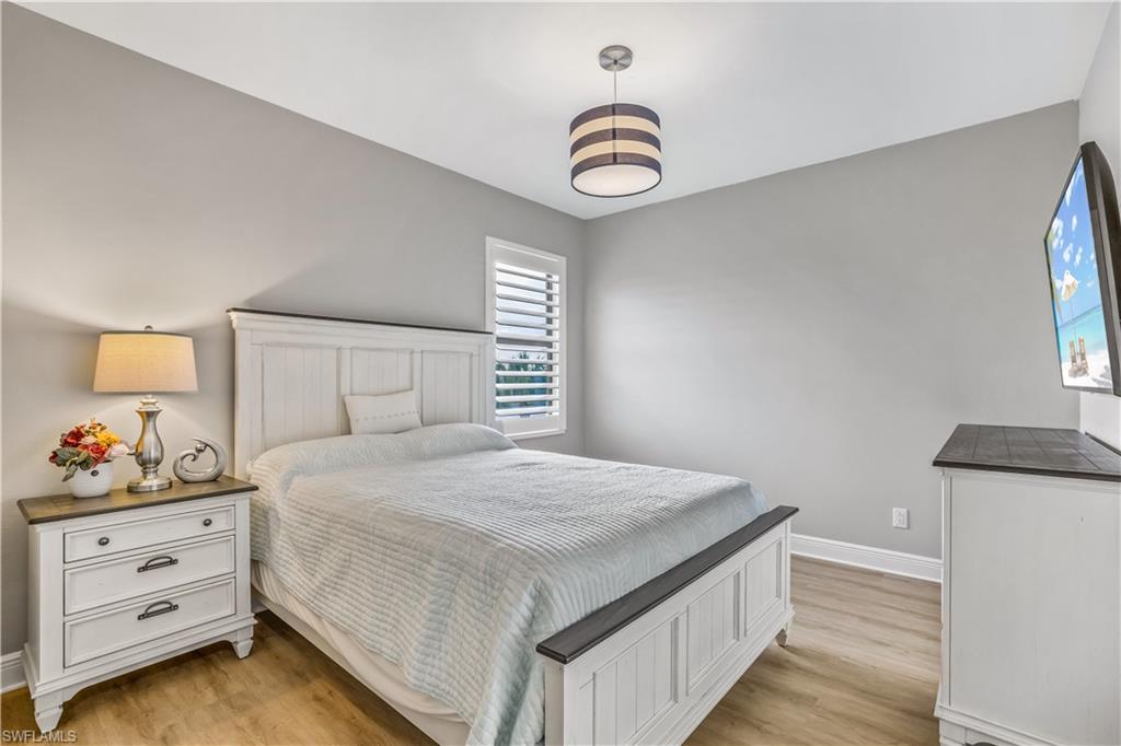 4605 Abaca Circle Naples, FL 34119 - Photo 18 of 35 a bedroom with a bed and a window