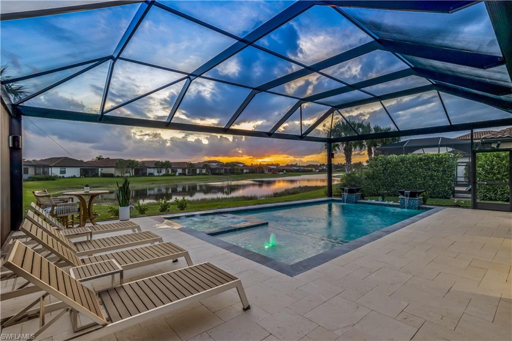 4605 Abaca Circle Naples, FL 34119 - Photo 24 of 35 a view of a swimming pool with a patio