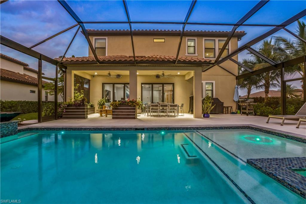 4605 Abaca Circle Naples, FL 34119 - Photo 25 of 35 a view of a swimming pool with a patio
