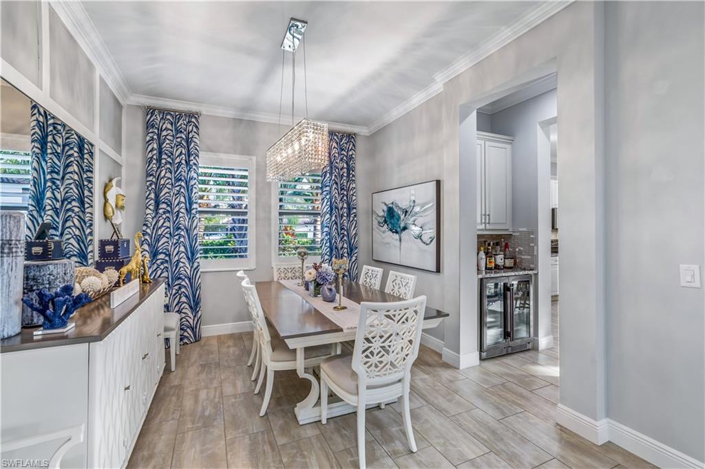4605 Abaca Circle Naples, FL 34119 - Photo 4 of 35 a view of a dining room with furniture window and wooden floor