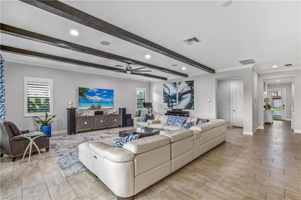 4605 Abaca Circle Naples, FL 34119 - Photo 5 of 35 a living room with furniture and a flat screen tv