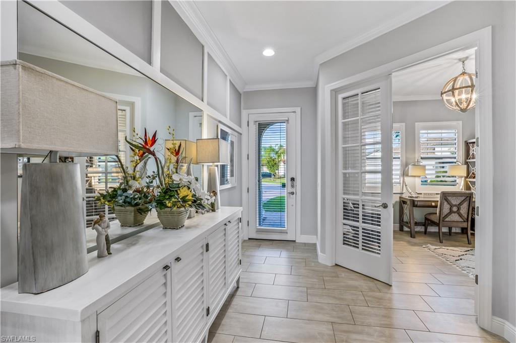 4605 Abaca Circle Naples, FL 34119 - Photo 8 of 35 a kitchen with counter top space and wooden floor