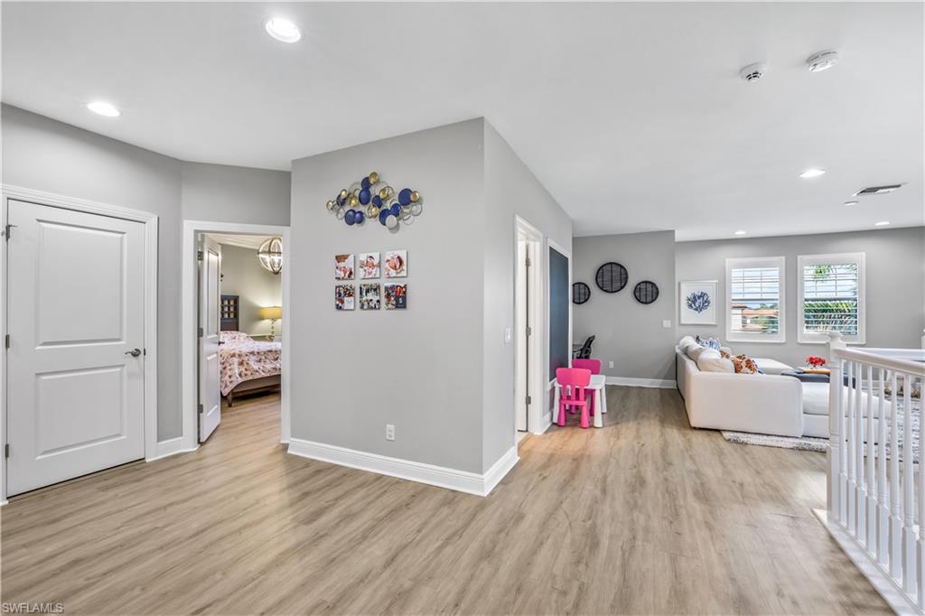 4605 Abaca Circle Naples, FL 34119 - Photo 10 of 35 a living room with furniture and wooden floor