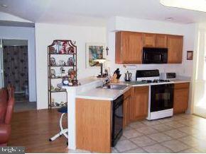 196 Torpedo Road Manahawkin, NJ 08050 - Photo 6 of 6 a kitchen with stainless steel appliances a stove a sink and a refrigerator