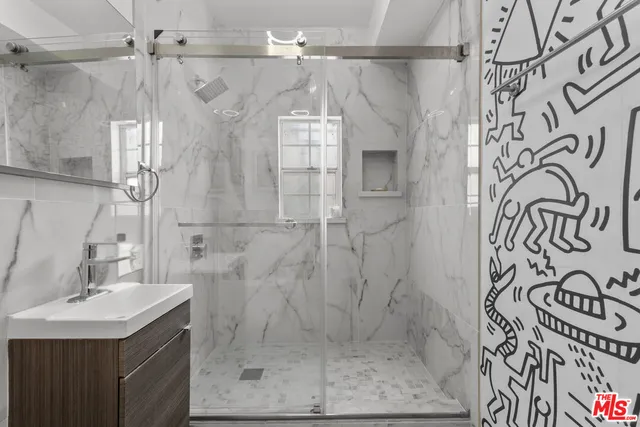 a bathroom with a shower and mirror