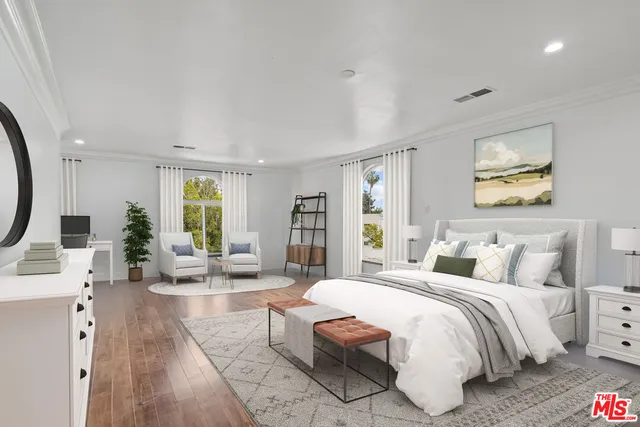 a spacious bedroom with a bed a couch and large window