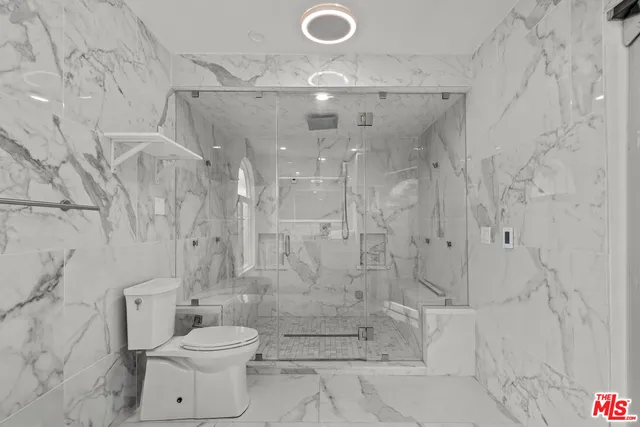 a bathroom with a shower and a toilet
