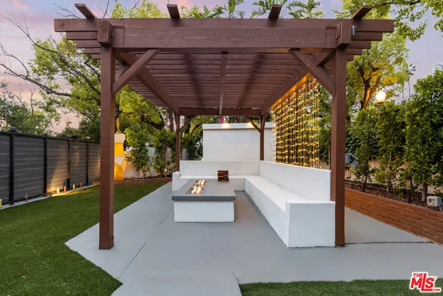 a view of patio with a table and chairs under an umbrella
