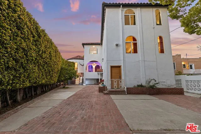 a view of a street with potted plants