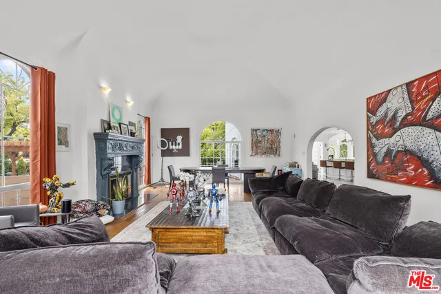 a living room with furniture a chandelier and a large window