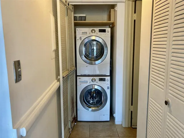a living room with furniture and a glass door shower